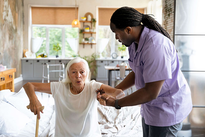 Professional healthcare worker providing compassionate care and support to an elderly woman in a comfortable home environment